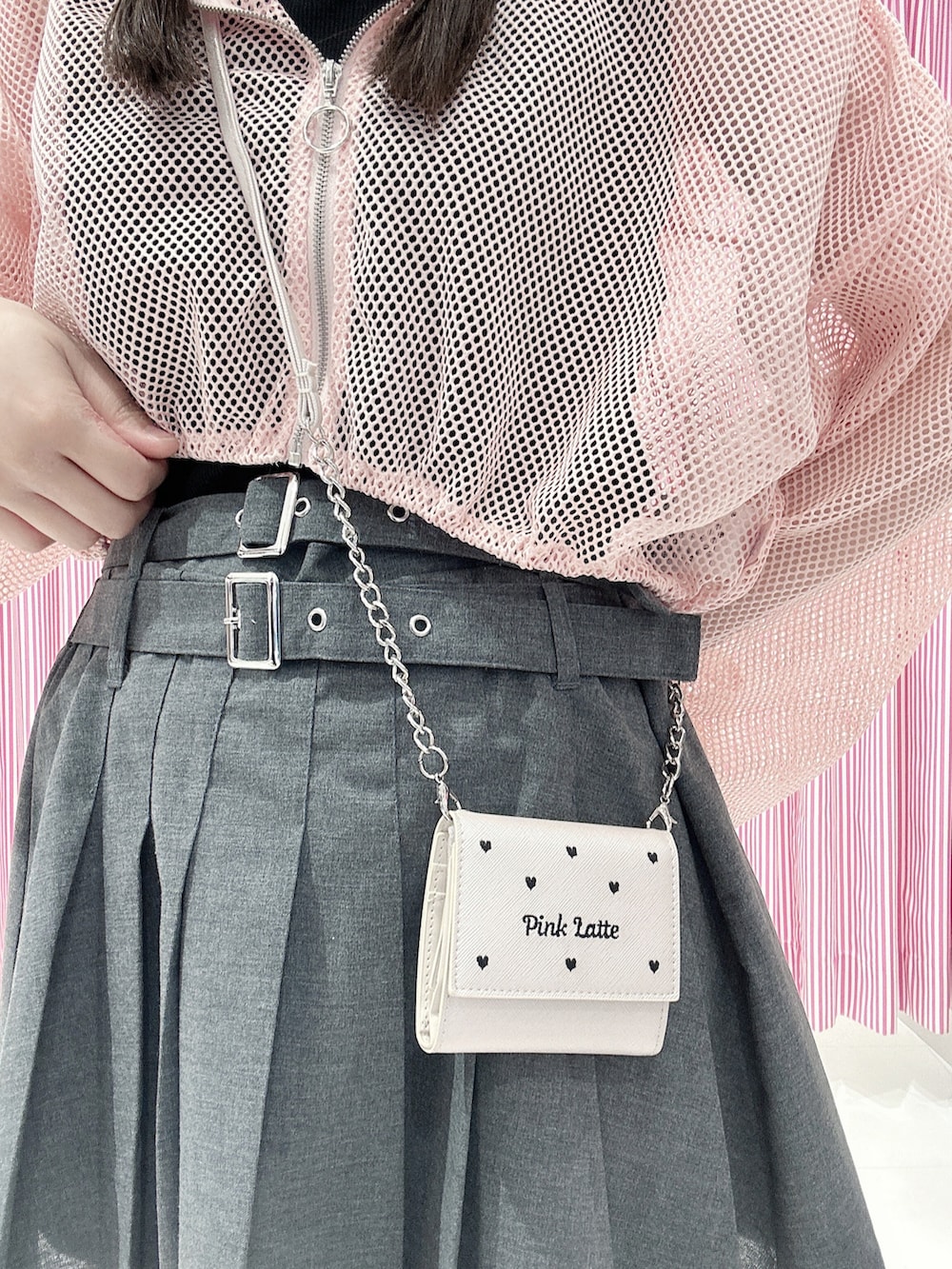 ブラック系のタンクトップ、ピンク系のパーカー、グレー系のスカートを着用したレディースの夏コーディネートの5枚目の写真