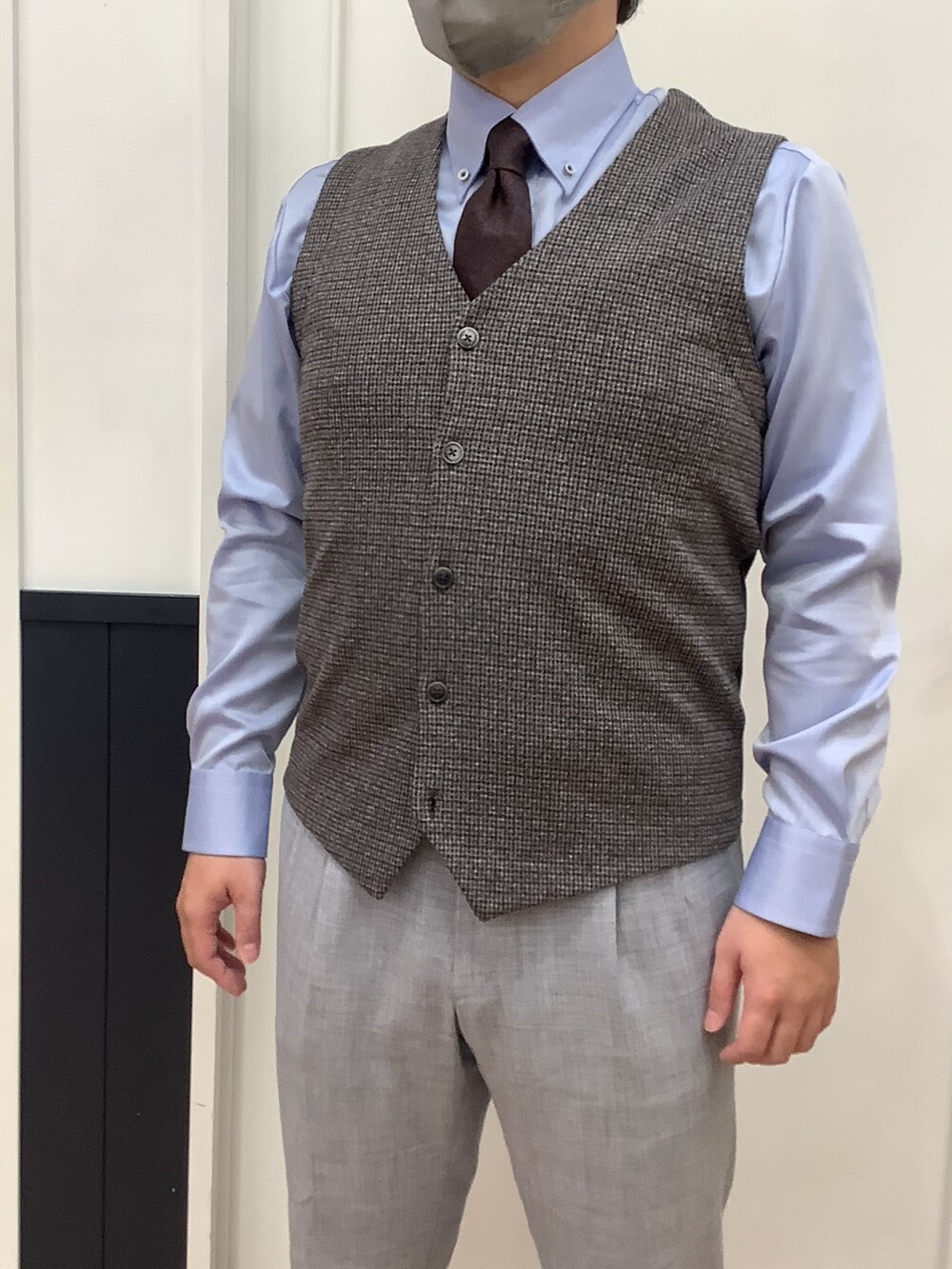 ブルー系のビジネスシャツ、グレー系のベストを着用したメンズの秋コーディネートの3枚目の写真