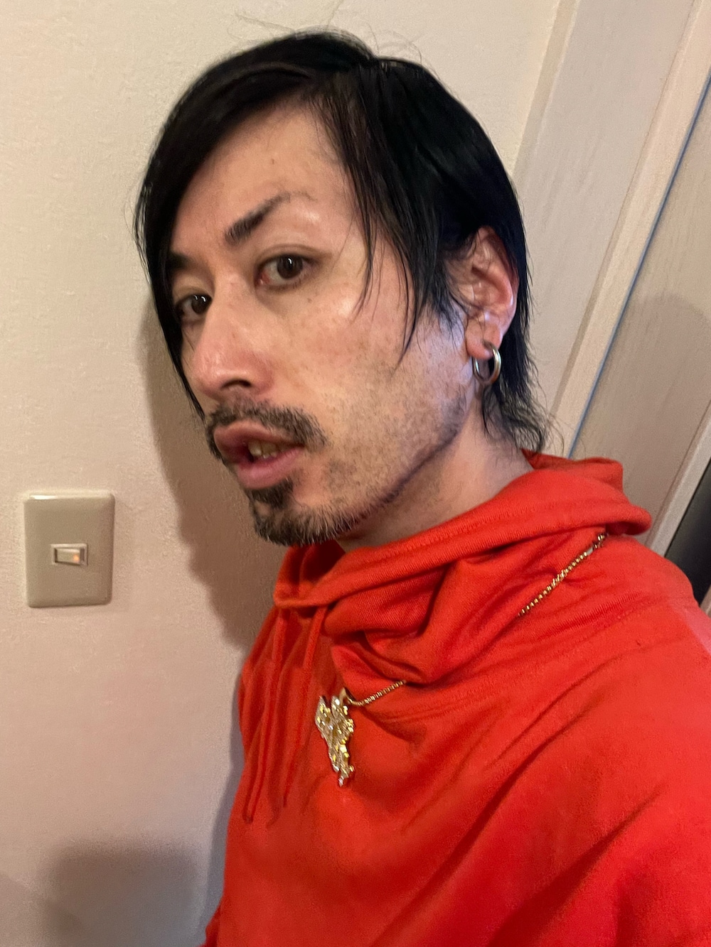 その他のチノパンツ、オレンジ系のスウェットを着用したメンズの冬コーディネートの4枚目の写真