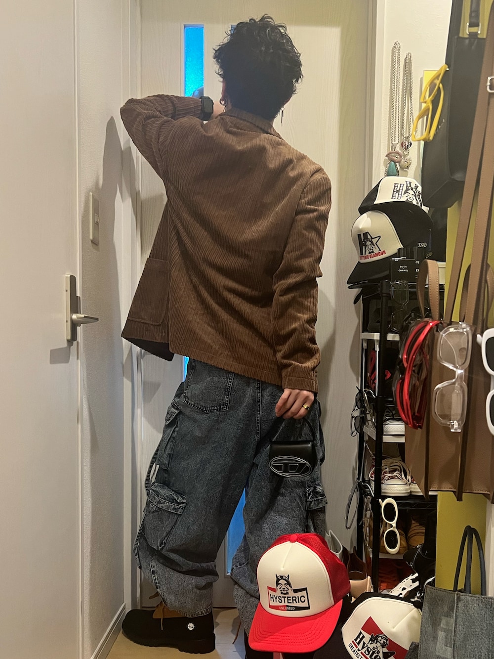 ブラウン系のテーラードジャケット、ブラック系のタンクトップ、ブラック系のショルダーバッグを着用したメンズの冬コーディネートの3枚目の写真