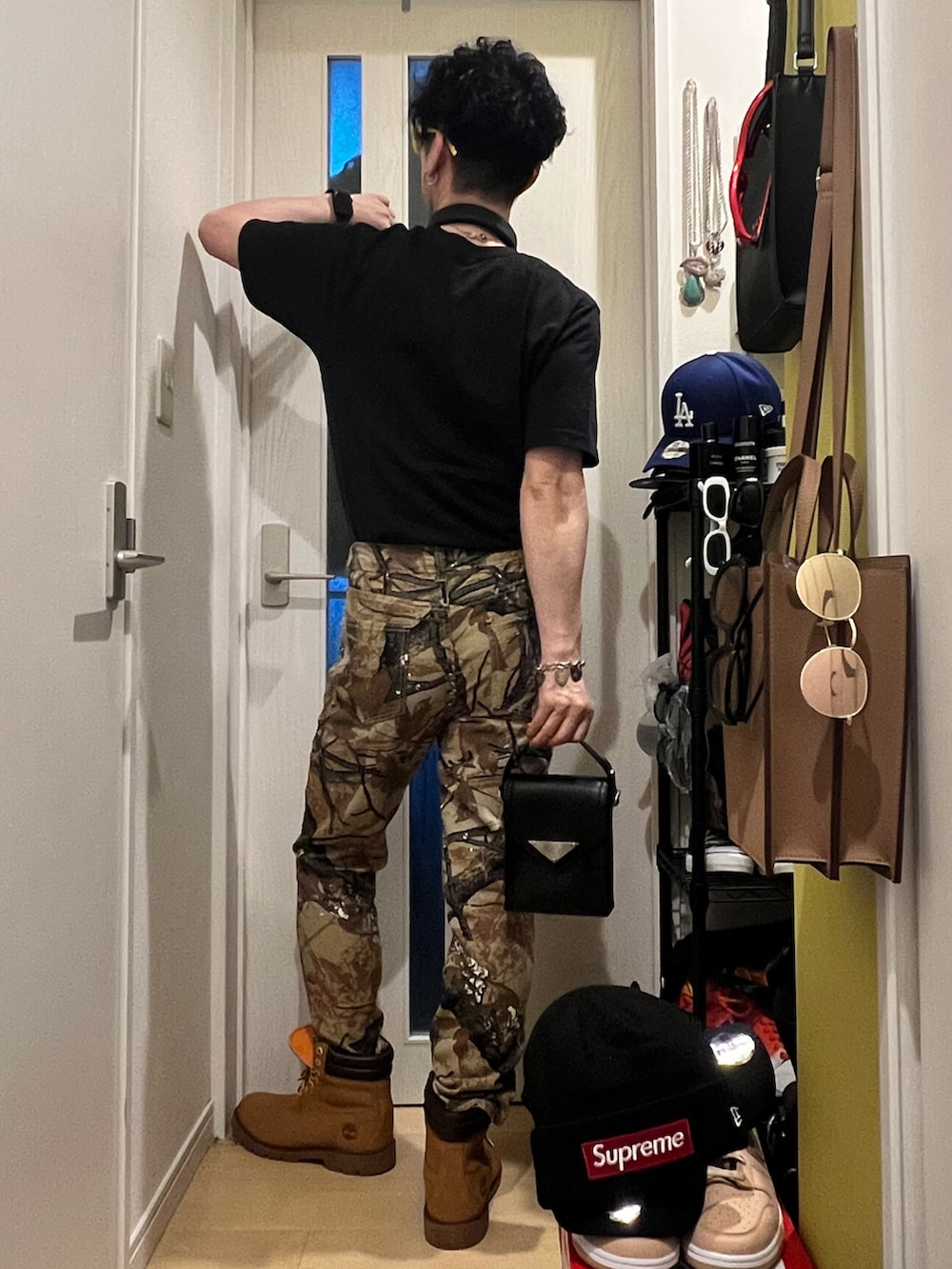 ベージュ系のブーツ、ブラック系のTシャツ/カットソー、ブラック系のショルダーバッグを着用したメンズの秋コーディネートの3枚目の写真