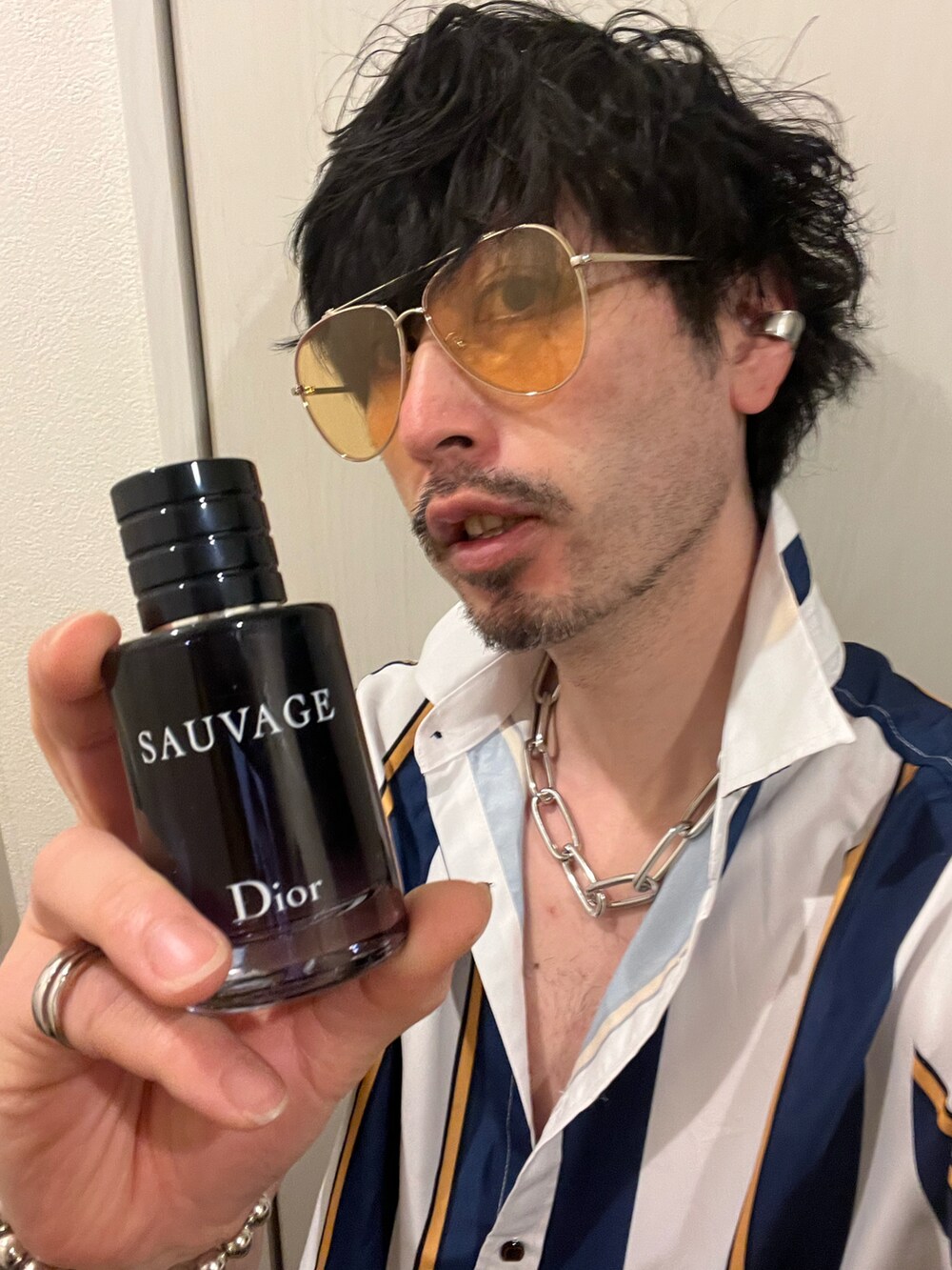 グレー系のトートバッグ、ブラック系のカーゴパンツ、ブラック系のサンダルを着用したメンズの春コーディネートの5枚目の写真