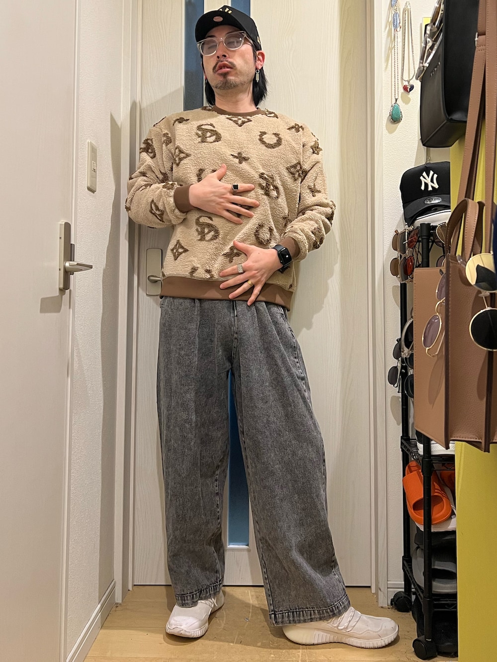 ブラック系のデニムパンツ、ベージュ系のスウェット、ホワイト系のスニーカーを着用したメンズの冬コーディネートの3枚目の写真