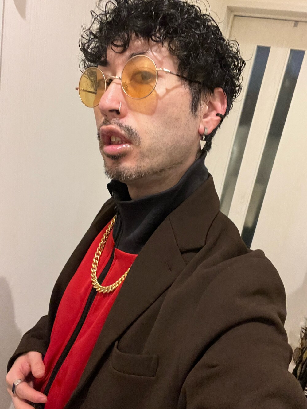 レッド系のジャージ、ホワイト系のスニーカー、ブラウン系のセットアップを着用したメンズの冬コーディネートの4枚目の写真