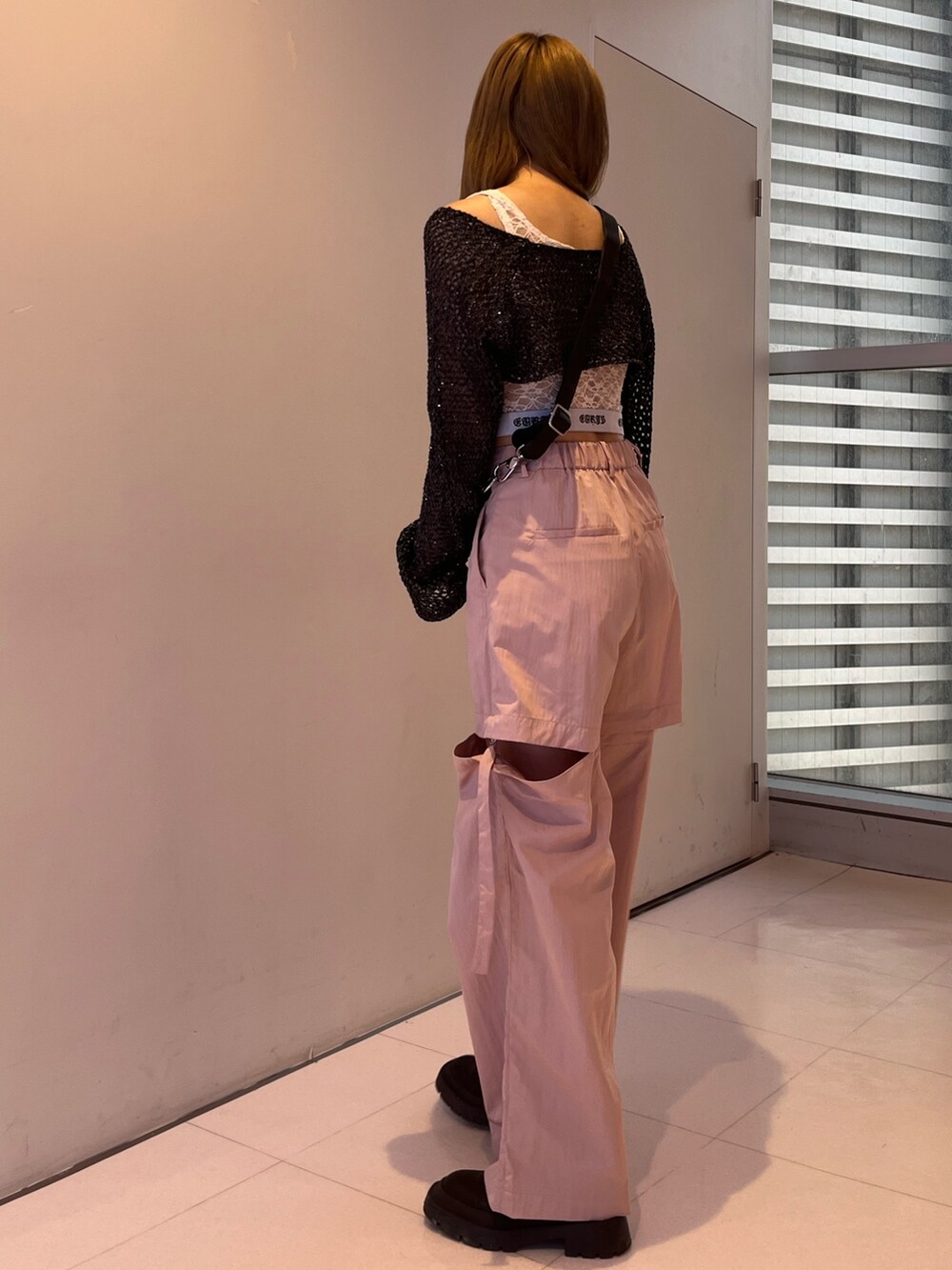 ピンク系のカーゴパンツ、ブラック系のキャミソール、ブラック系のニット/セーターを着用したレディースの春コーディネートの4枚目の写真