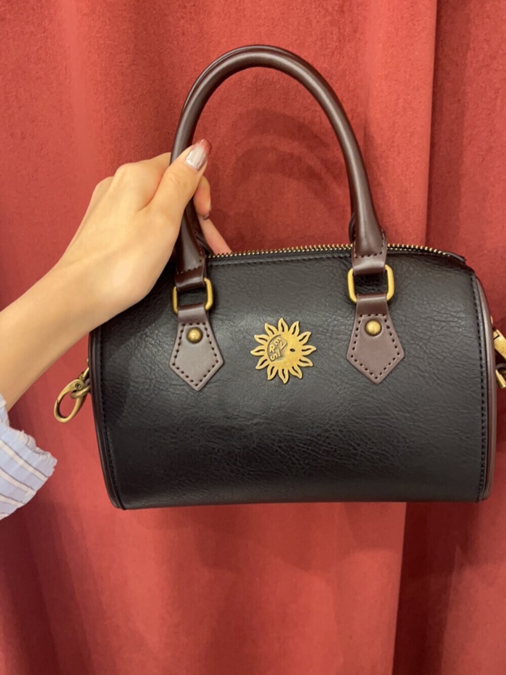 ブラック系のブーツ、ブルー系のデニムパンツ、その他のショルダーバッグを着用したレディースの春コーディネートの6枚目の写真