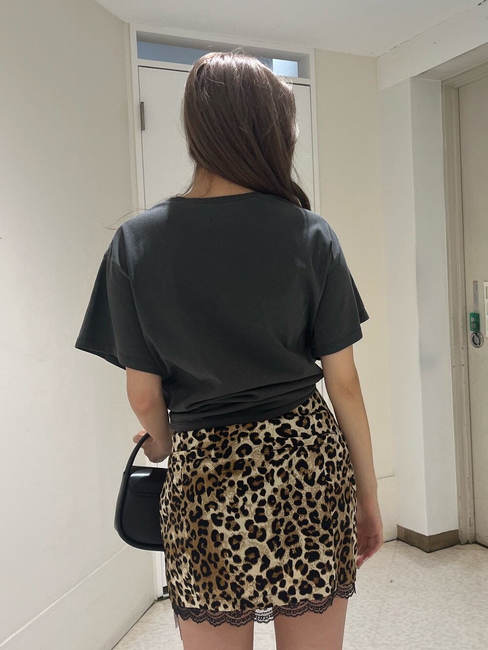 ブラック系のTシャツ/カットソー、ベージュ系のスカート、ブラック系のハンドバッグを着用したレディースの夏コーディネートの5枚目の写真