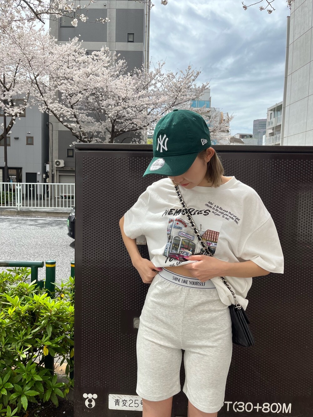 ブラック系のショルダーバッグ、ホワイト系のTシャツ/カットソー、グレー系のその他パンツを着用したレディースの春コーディネートの6枚目の写真