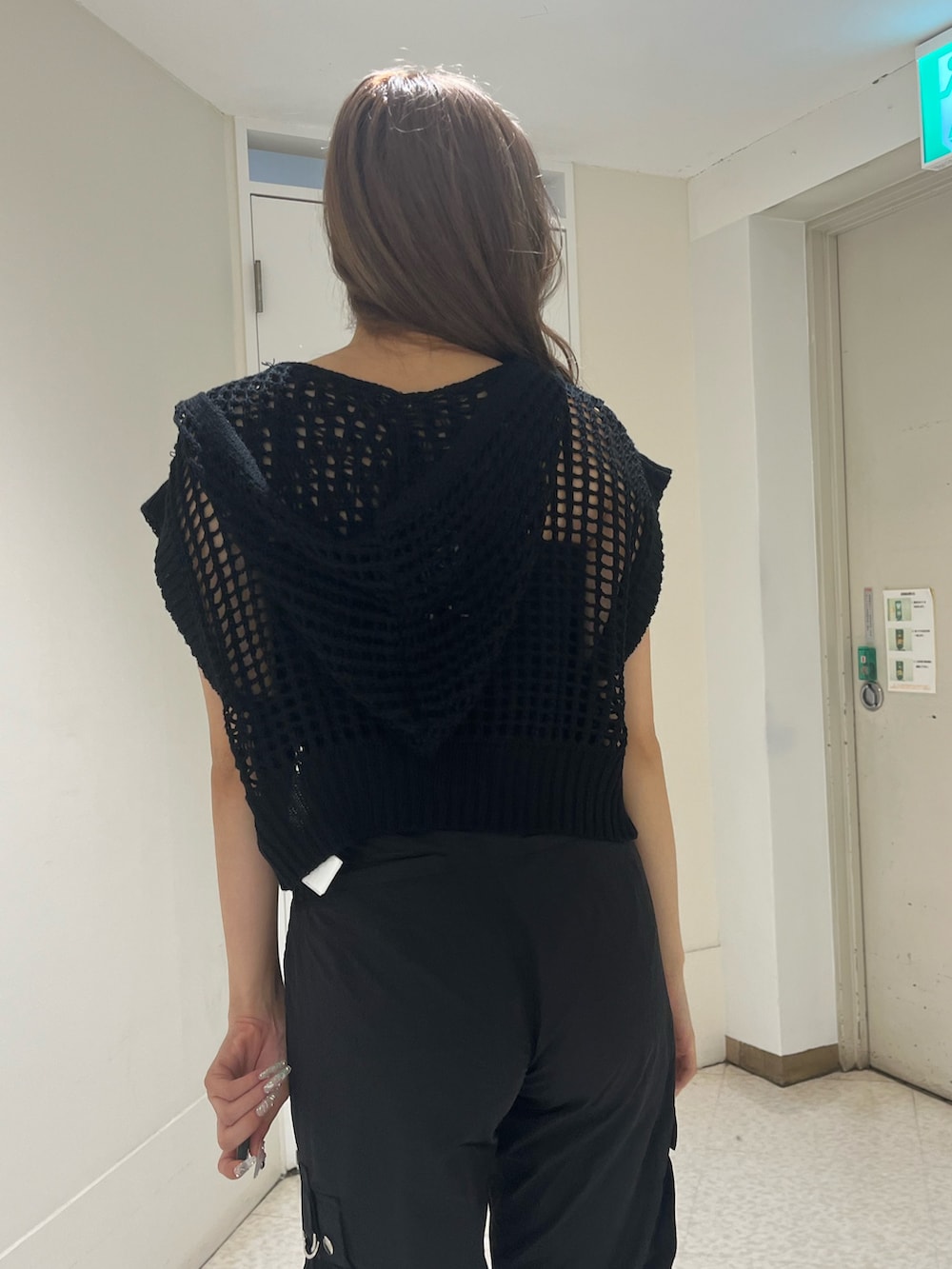 ブラック系のニット/セーター、ブラック系のキャミソール、ブラック系のカーゴパンツを着用したレディースの夏コーディネートの6枚目の写真