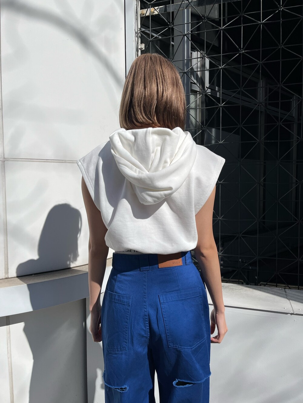 ブルー系のその他パンツ、ホワイト系のサンダル、ホワイト系のスウェットを着用したレディースの春コーディネートの5枚目の写真