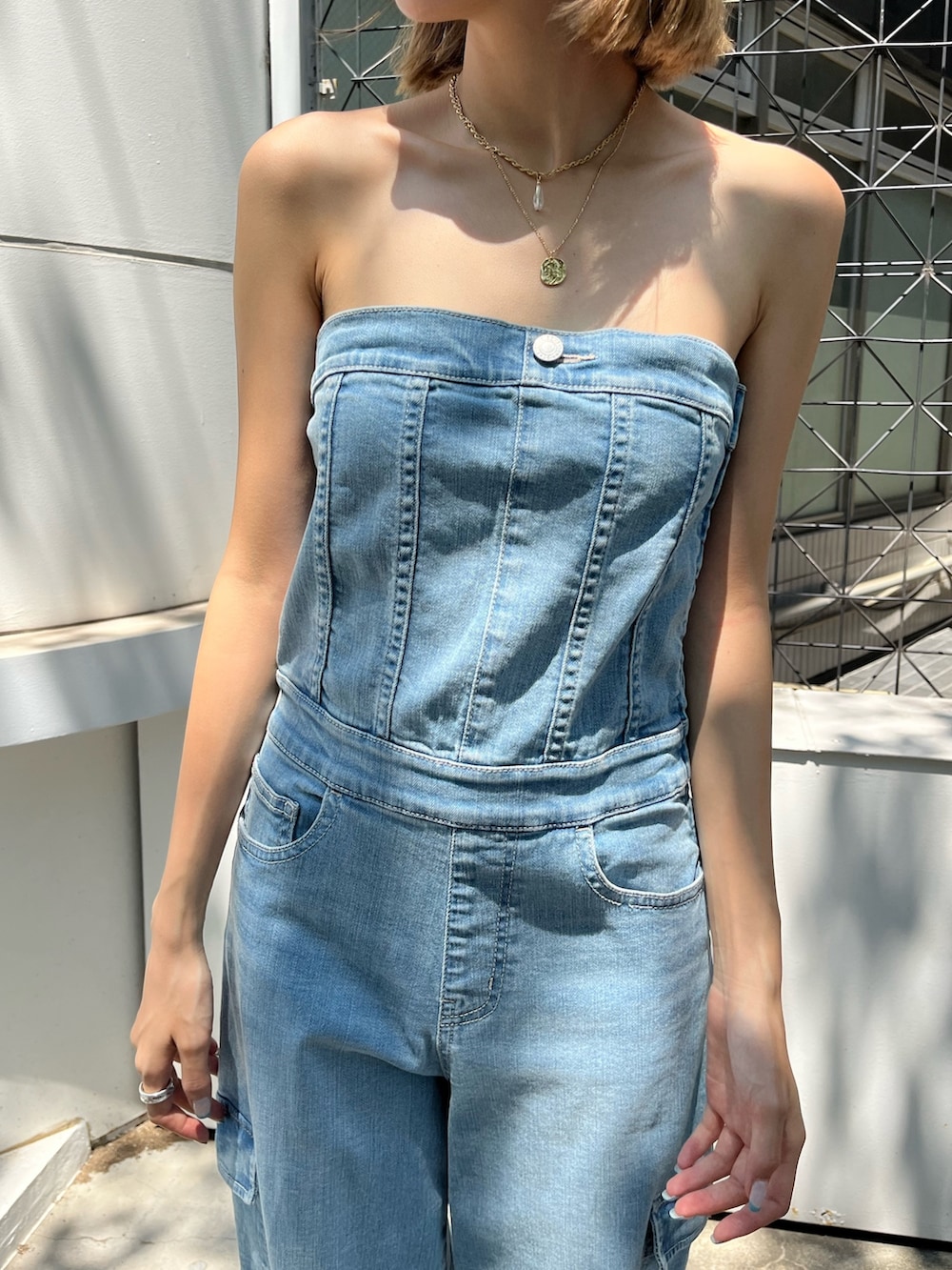 ブルー系のつなぎ/オールインワン、ホワイト系のブーツ、ブラック系のサングラスを着用したレディースの夏コーディネートの4枚目の写真