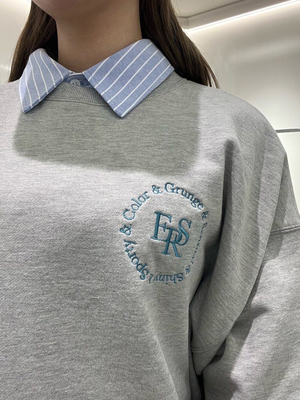 ホワイト系のシャツ/ブラウス、ホワイト系のスウェット、シルバー系のブーツを着用したレディースの春コーディネートの7枚目の写真