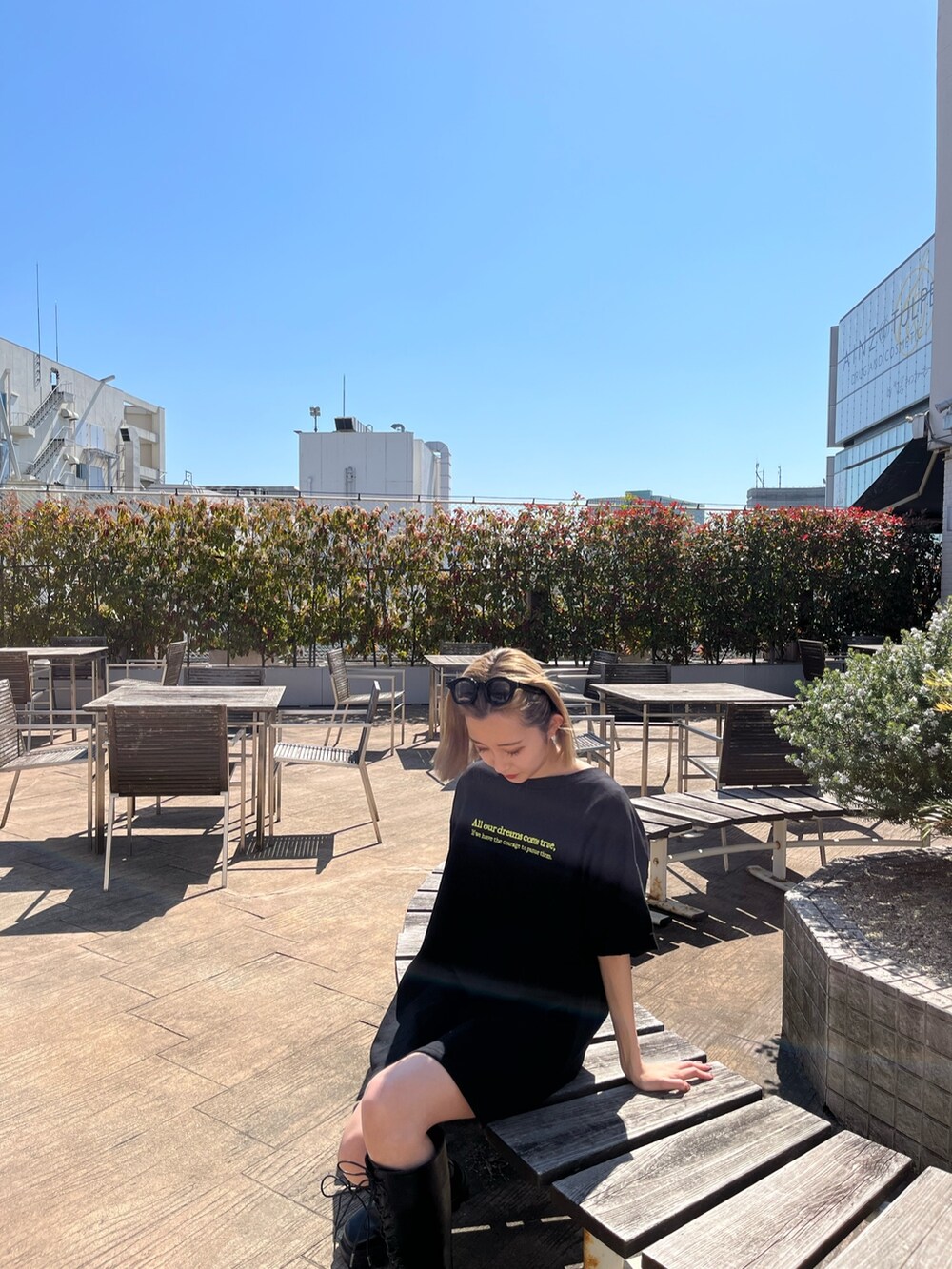 ブラック系のTシャツ/カットソー、ブラック系のブーツ、ブラック系のサングラスを着用したレディースの春コーディネートの5枚目の写真