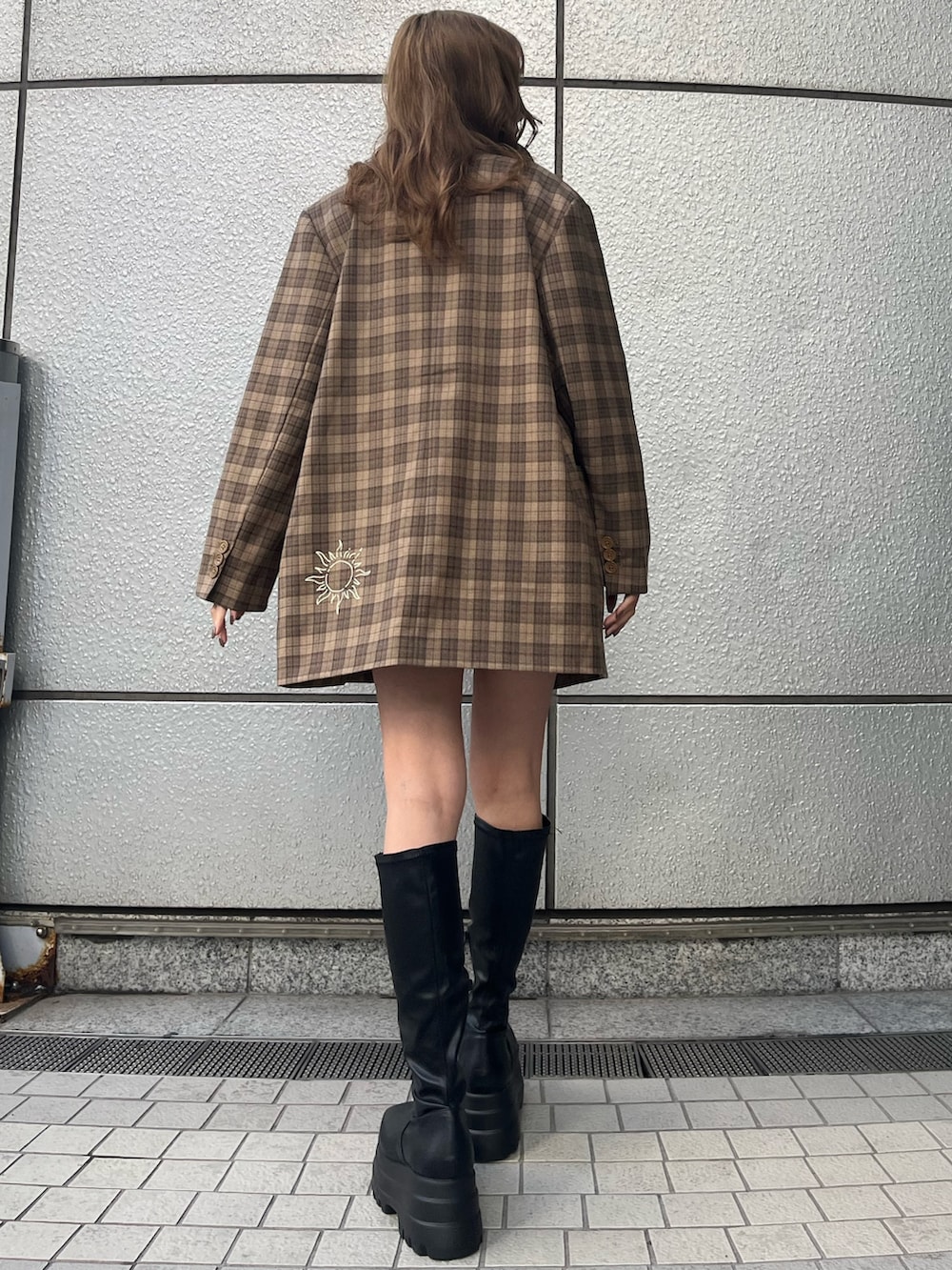 ブラック系のブーツ、ブラック系のTシャツ/カットソー、ブラック系のデニムスカートを着用したレディースの冬コーディネートの3枚目の写真