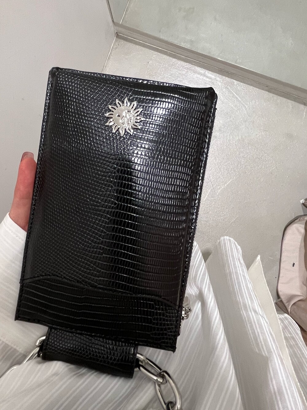 ブラック系のサンダル、ブラック系のミリタリージャケット、オレンジ系のワンピースを着用したレディースの春コーディネートの7枚目の写真