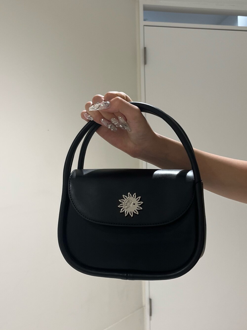 ブルー系のシャツ/ブラウス、ベージュ系のスカート、ブラック系のハンドバッグを着用したレディースの夏コーディネートの6枚目の写真