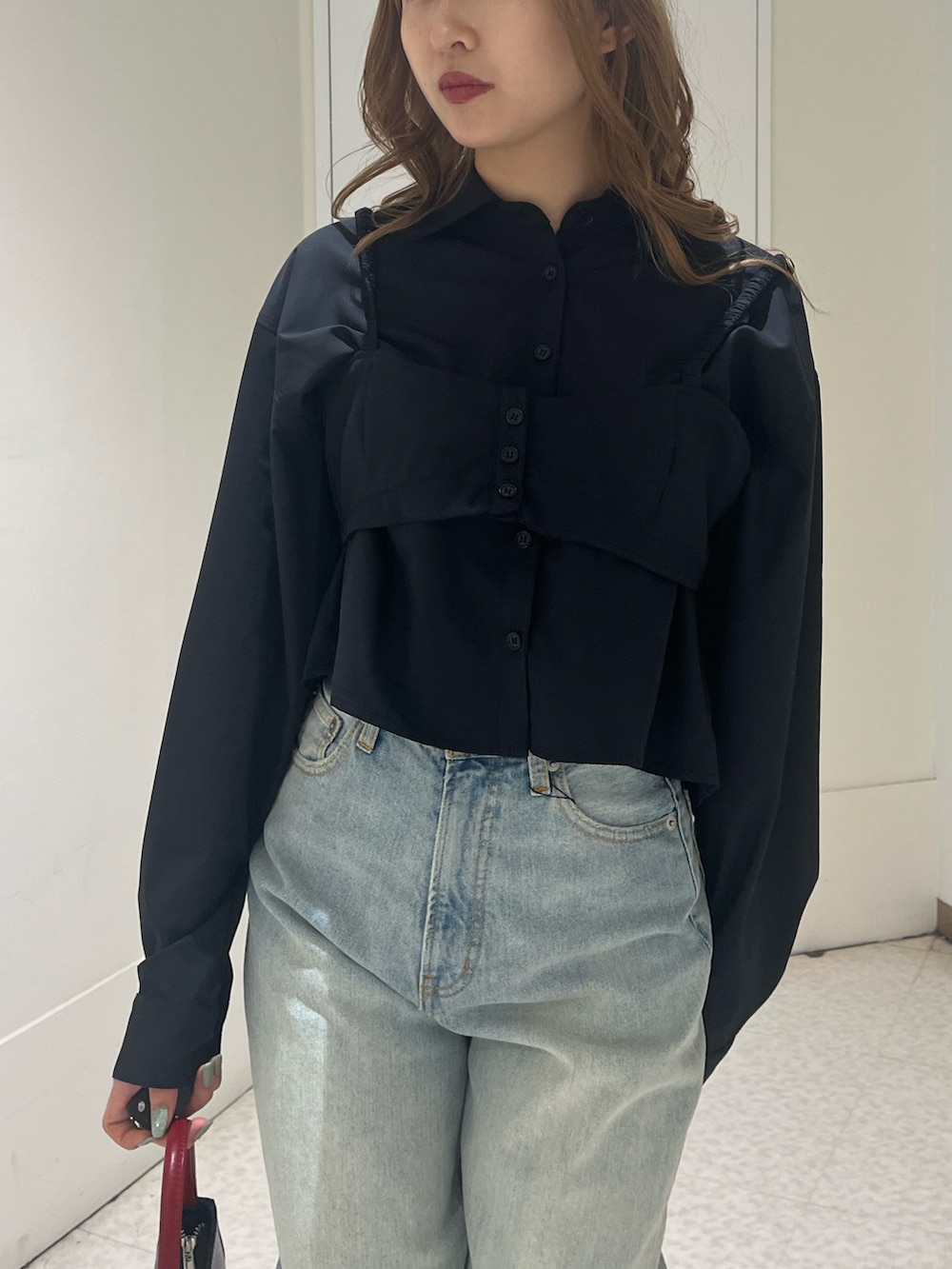 ブラック系のシャツ/ブラウス、ブルー系のデニムパンツ、ブラウン系のハンドバッグを着用したレディースの春コーディネートの4枚目の写真