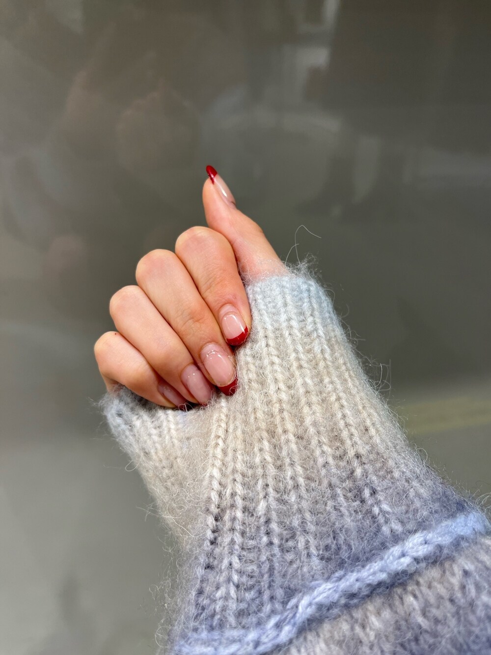 パープル系のニット/セーター、ブラック系のブーツ、ブラック系のベルトを着用したレディースの冬コーディネートの4枚目の写真