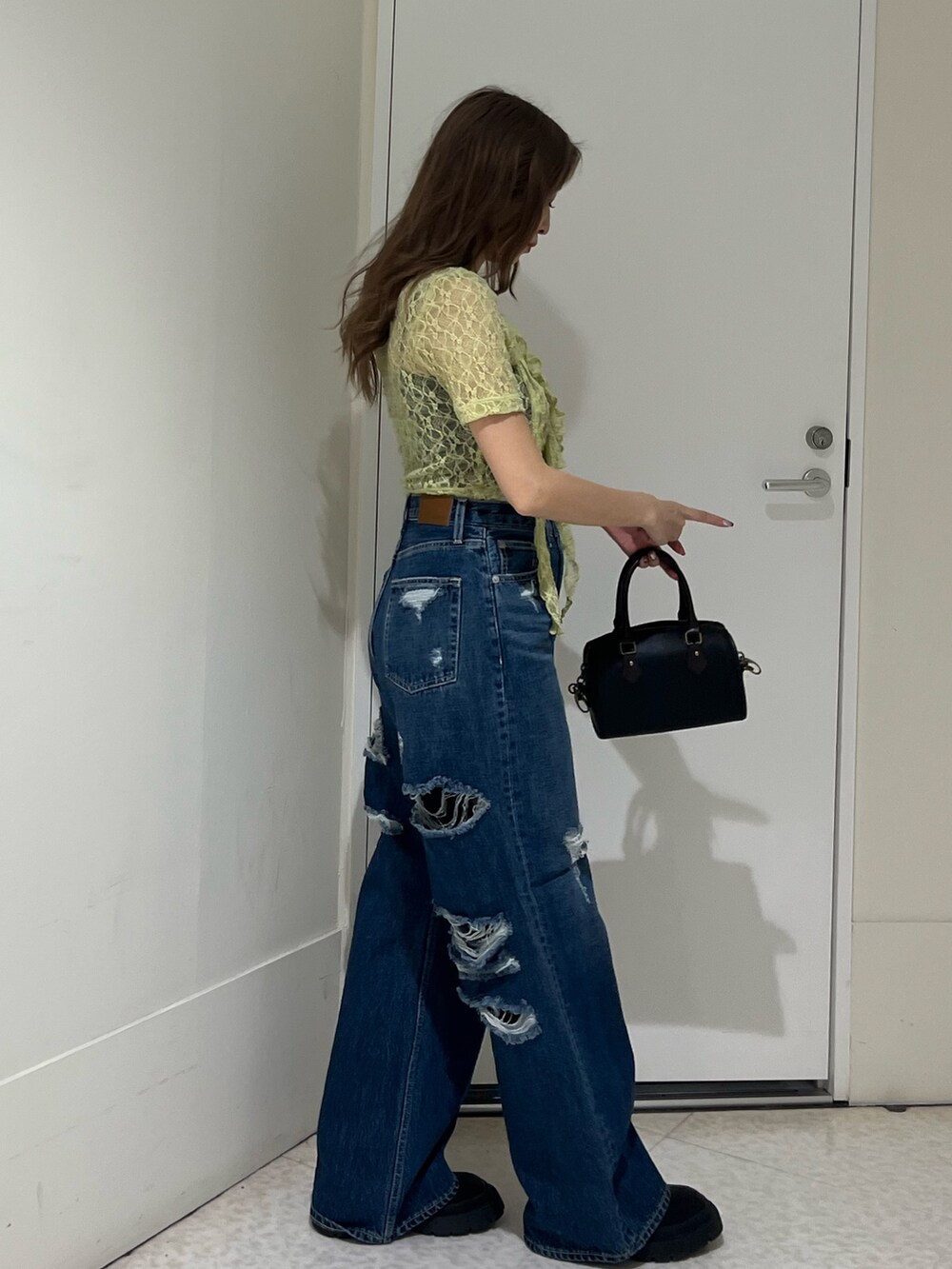 イエロー系のTシャツ/カットソー、ブルー系のデニムパンツ、その他のショルダーバッグを着用したレディースの春コーディネートの4枚目の写真