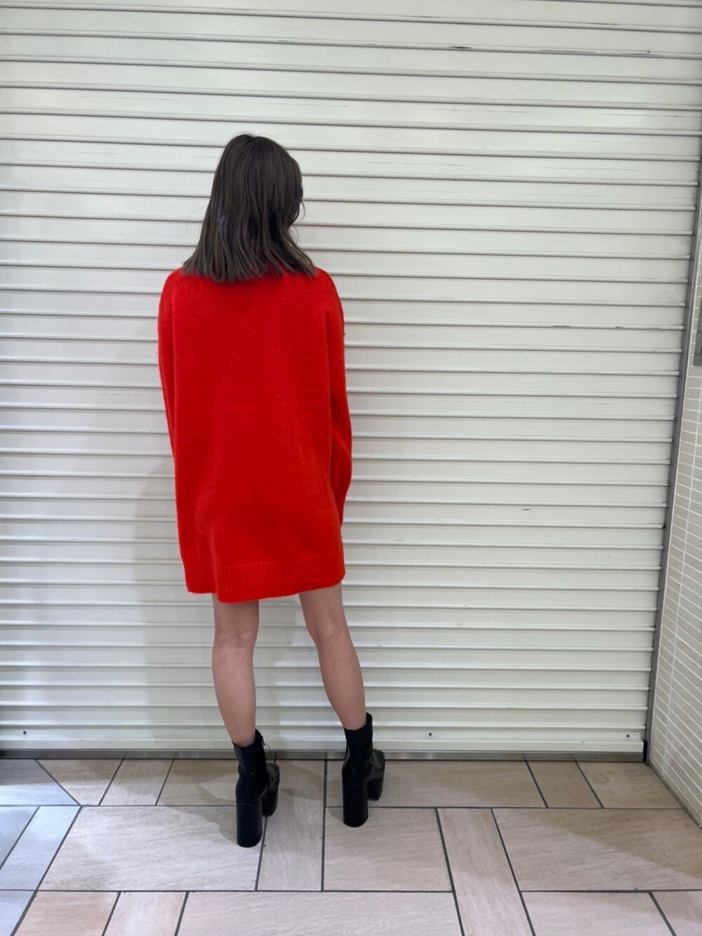 ホワイト系のブルゾン、レッド系のワンピースを着用したレディースの秋コーディネートの3枚目の写真