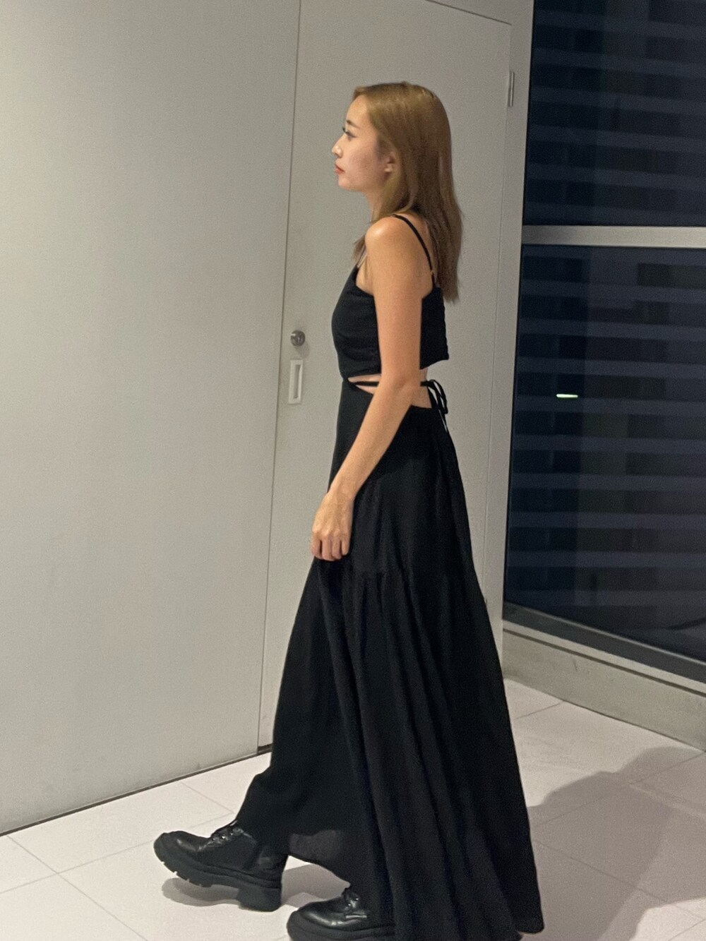 ブラック系のワンピース、シルバー系のブーツを着用したレディースの夏コーディネートの2枚目の写真