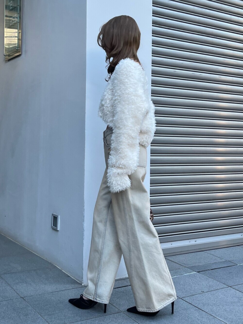 ホワイト系のカーディガン/ボレロ、ベージュ系のデニムパンツ、ブラック系のサンダルを着用したレディースの冬コーディネートの3枚目の写真
