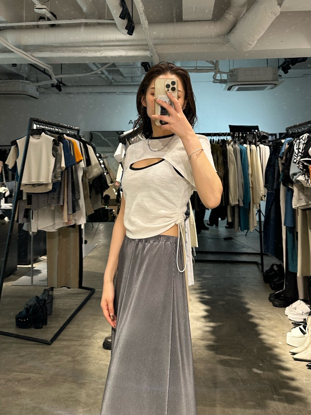 グレー系のスカート、ブラック系のサンダル、ホワイト系のTシャツ/カットソーを着用したレディースの夏コーディネートの4枚目の写真