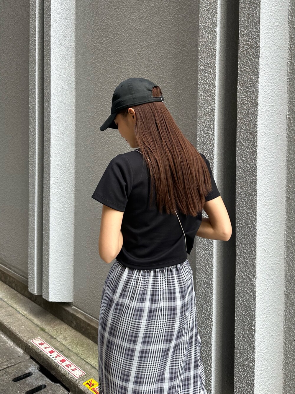 ブラック系のTシャツ/カットソー、ブラック系のパンプス、ブラック系のスカートを着用したレディースの秋コーディネートの6枚目の写真