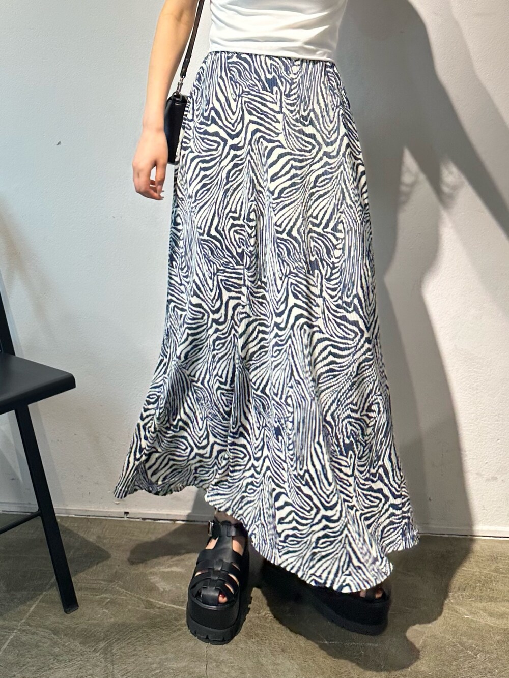 その他のスカート、ブラック系のショルダーバッグ、ブラック系のサンダルを着用したレディースの春コーディネートの8枚目の写真