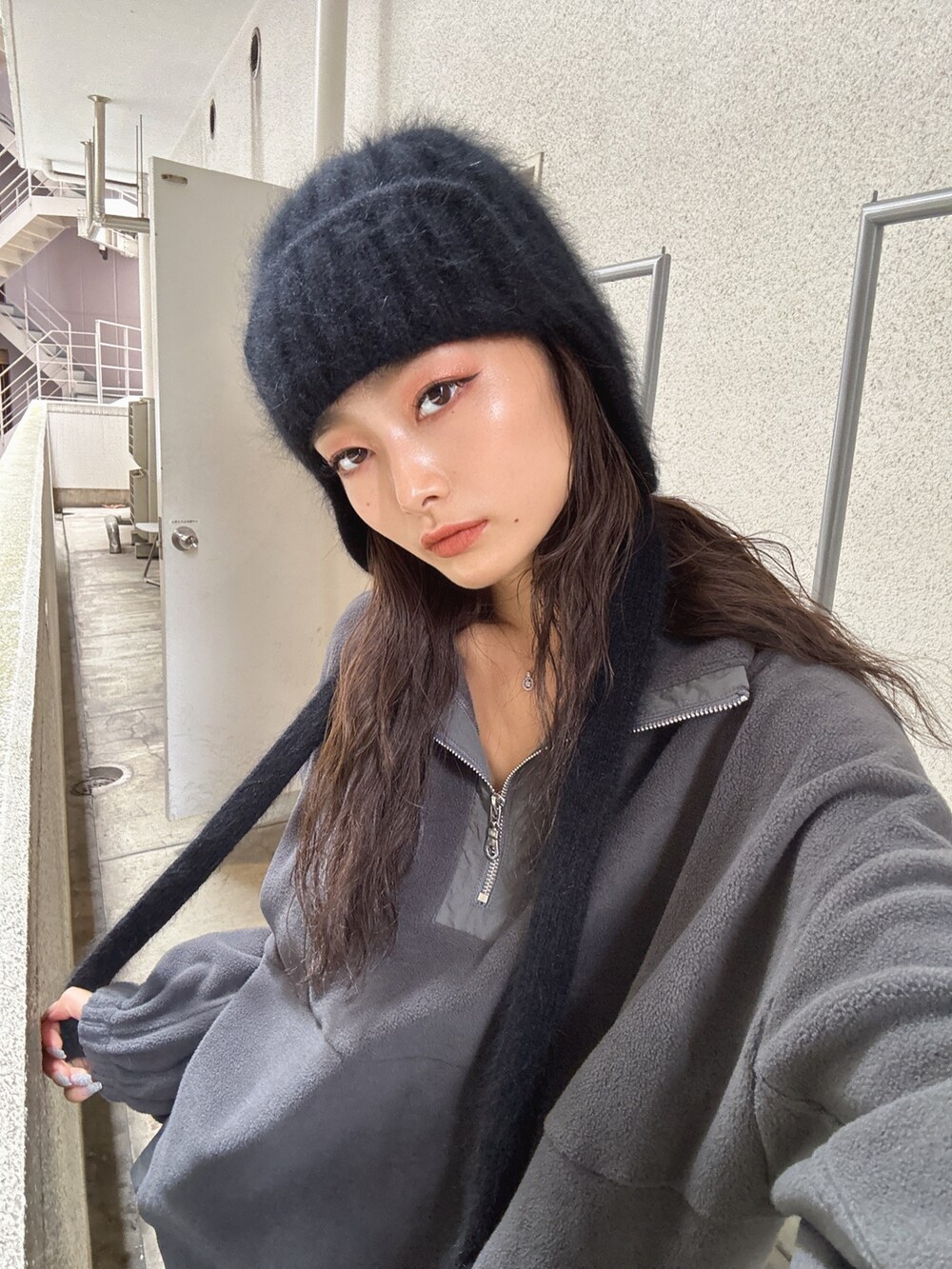 グレー系のTシャツ/カットソー、グレー系のスカート、ブラック系のブーツを着用したレディースの秋コーディネートの7枚目の写真