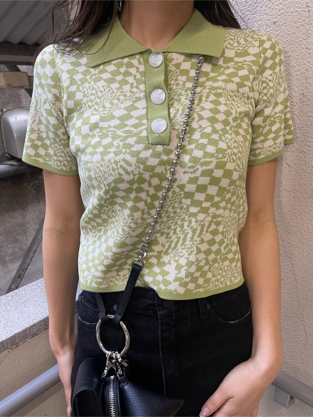 ブラック系のブーツ、ブラック系のハンドバッグ、ブラック系のデニムパンツを着用したレディースの春コーディネートの8枚目の写真