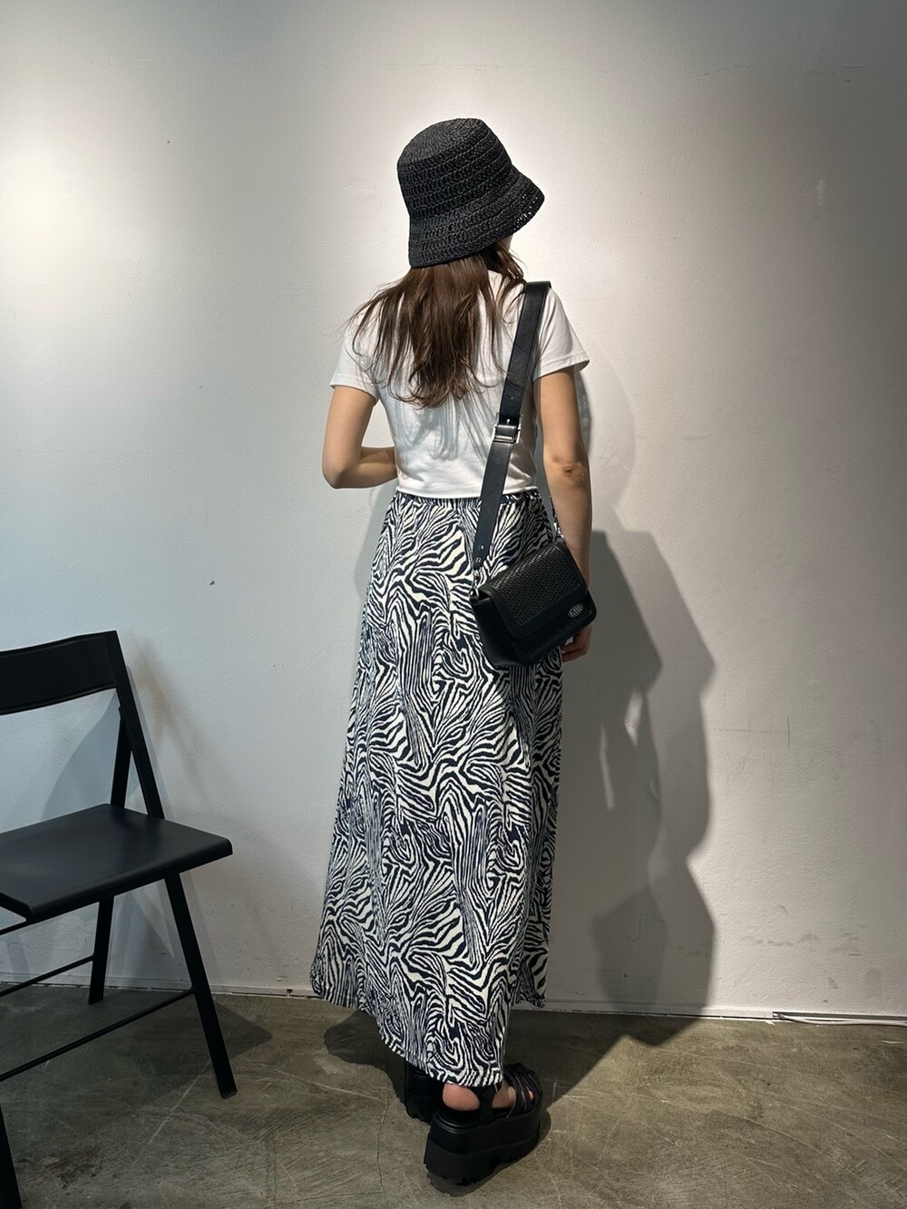 その他のスカート、ブラック系のショルダーバッグ、ブラック系のサンダルを着用したレディースの春コーディネートの3枚目の写真