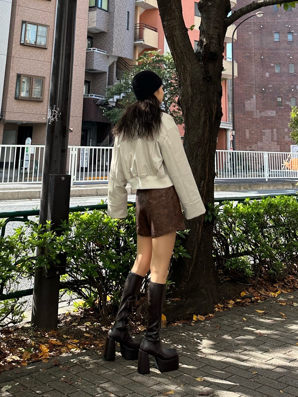 ブラウン系のその他パンツ、ホワイト系のブルゾン、ブラック系のニット/セーターを着用したレディースの秋コーディネートの2枚目の写真