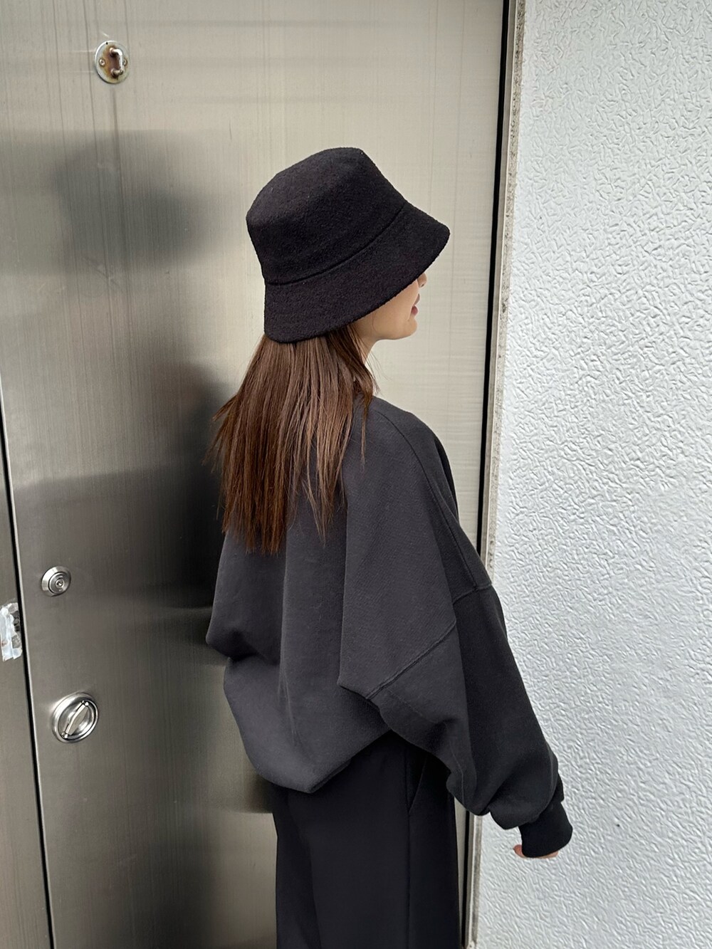 ブラック系のその他パンツ、ブラック系のハンドバッグ、ブラック系のTシャツ/カットソーを着用したレディースの冬コーディネートの5枚目の写真