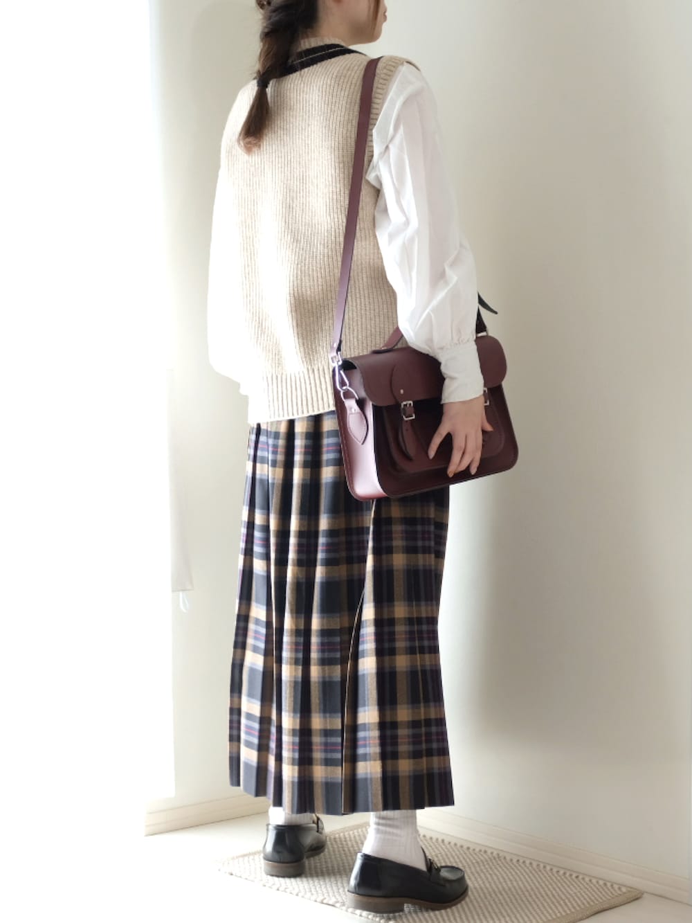 ホワイト系のシャツ/ブラウス、ベージュ系のスカート、ベージュ系のベストを着用したレディースの秋コーディネートの2枚目の写真