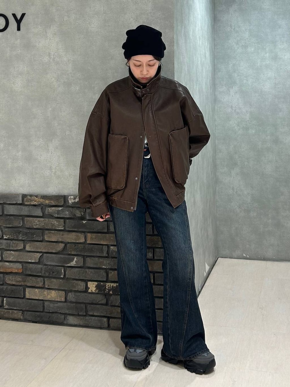 グレー系のスニーカー、ブルー系のデニムパンツ、ブラック系のTシャツ/カットソーを着用したレディースの秋コーディネートの9枚目の写真