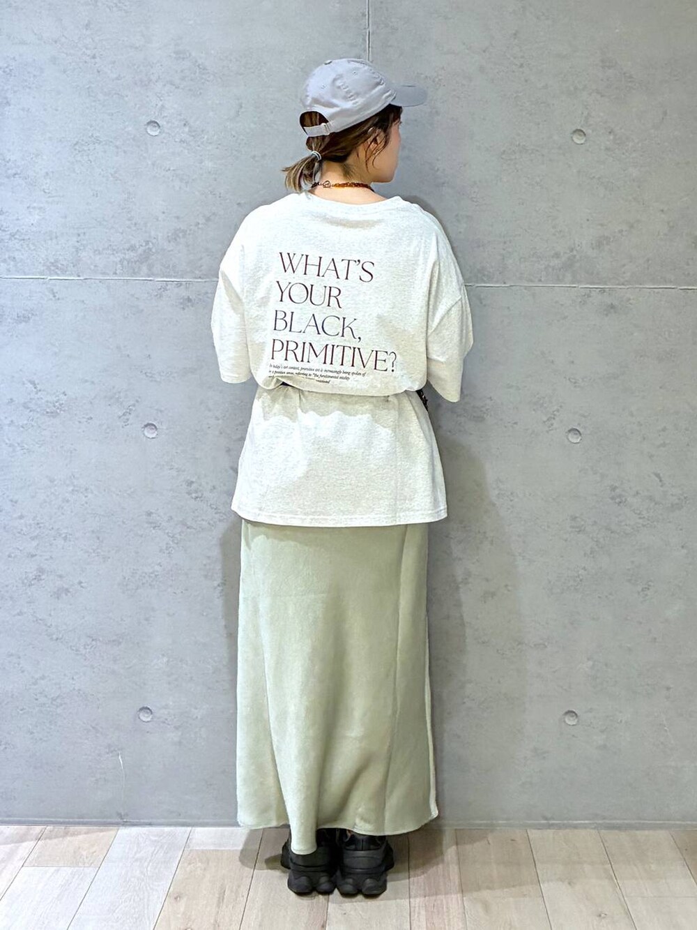 グリーン系のスカート、グレー系のTシャツ/カットソー、イエロー系のネックレスを着用したレディースの春コーディネートの3枚目の写真