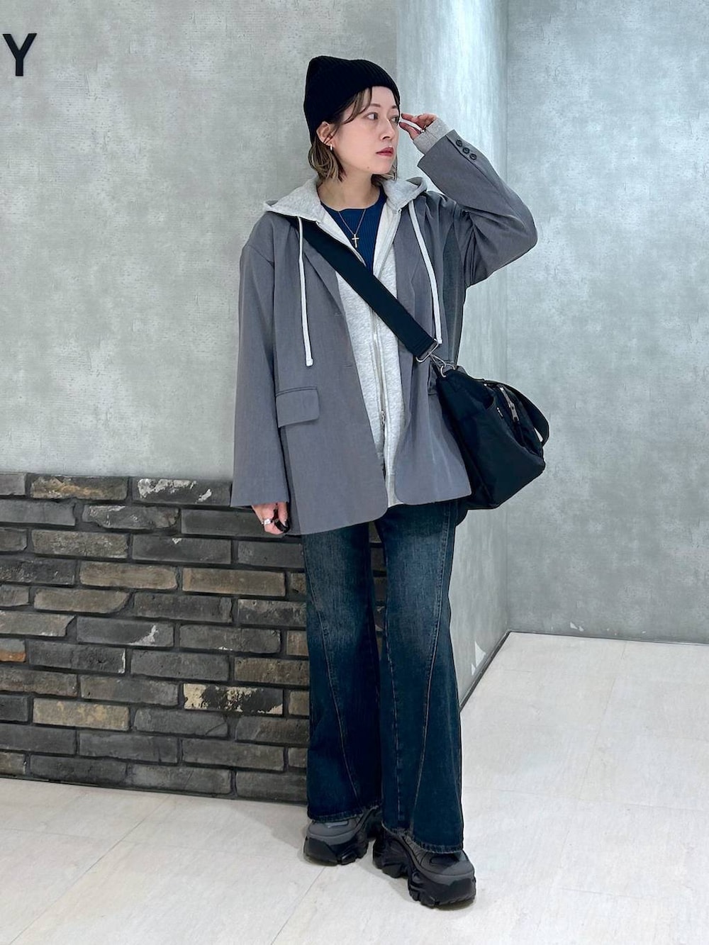 グレー系のスニーカー、ブルー系のデニムパンツ、グレー系のテーラードジャケットを着用したレディースの秋コーディネートの2枚目の写真