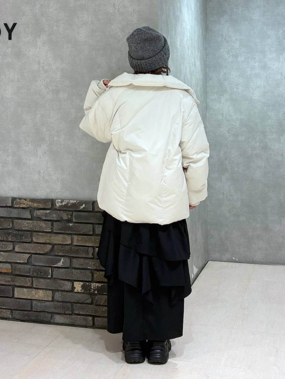 ブラック系のスニーカー、グリーン系のスウェット、ブラック系のスカートを着用したレディースの冬コーディネートの4枚目の写真