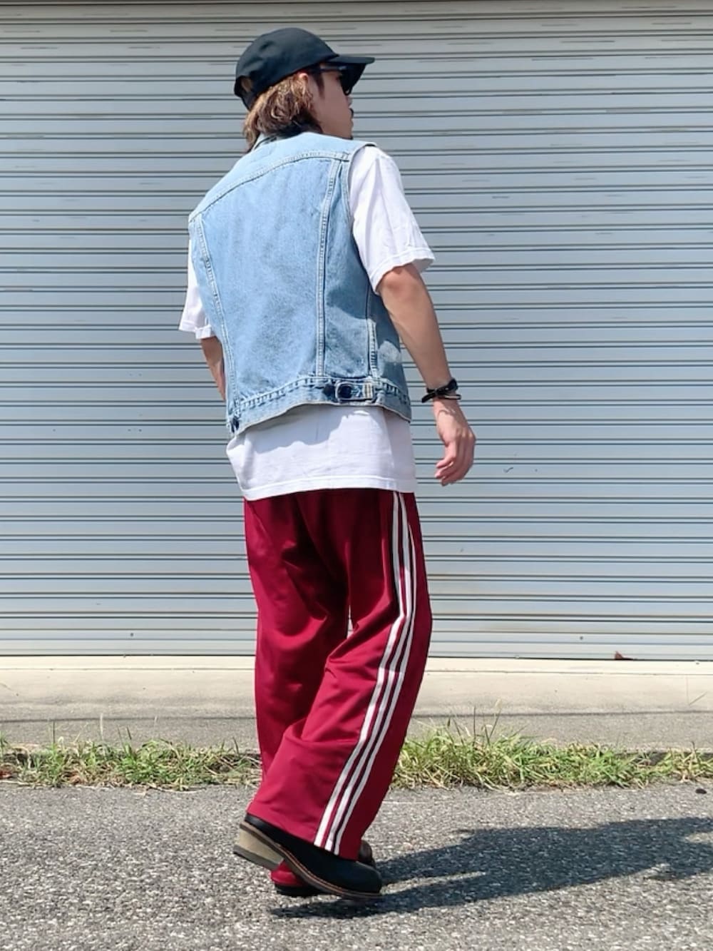 ホワイト系のTシャツ/カットソー、ブルー系のベスト、レッド系のその他パンツを着用したメンズの秋コーディネートの2枚目の写真