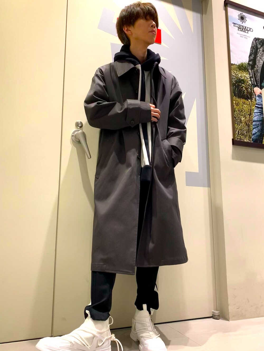 グレー系のステンカラーコート、グレー系のTシャツ/カットソー、ブラック系のその他パンツを着用したメンズの秋コーディネートの2枚目の写真