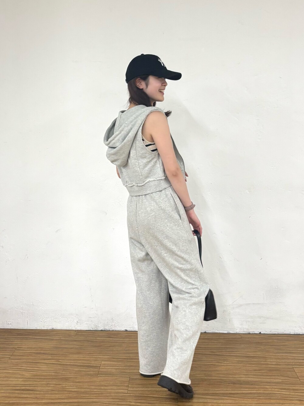 グレー系のスウェットパンツ、グレー系のTシャツ/カットソー、ホワイト系のタンクトップを着用したレディースの夏コーディネートの2枚目の写真