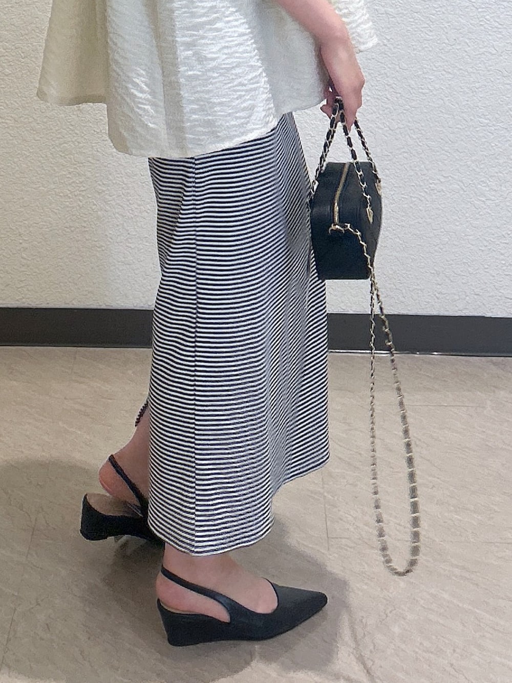 ブルー系のワンピース、ホワイト系のキャミソール、レッド系のショルダーバッグを着用したレディースの夏コーディネートの3枚目の写真