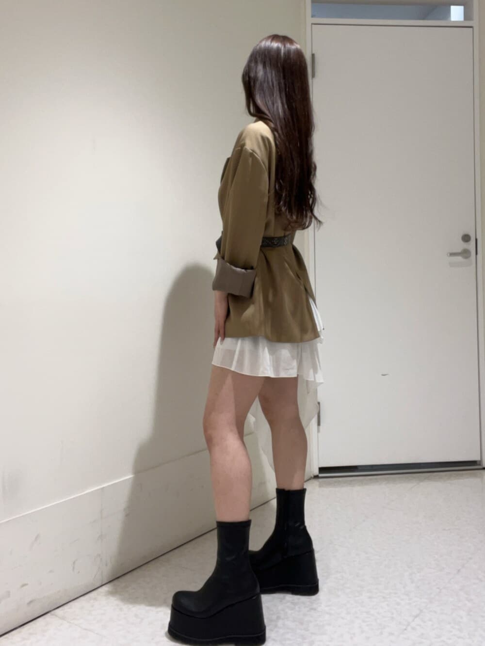 ブラウン系のテーラードジャケット、ホワイト系のワンピース、ブラウン系のベルトを着用したレディースの春コーディネートの2枚目の写真