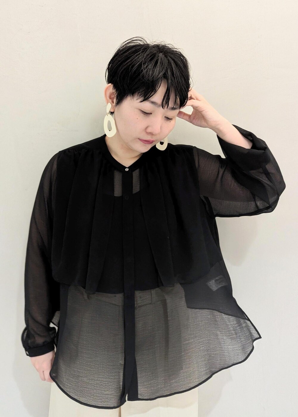 ブラック系のハンドバッグ、ブラック系のパンプス、ホワイト系のその他パンツを着用したレディースの春コーディネートの4枚目の写真