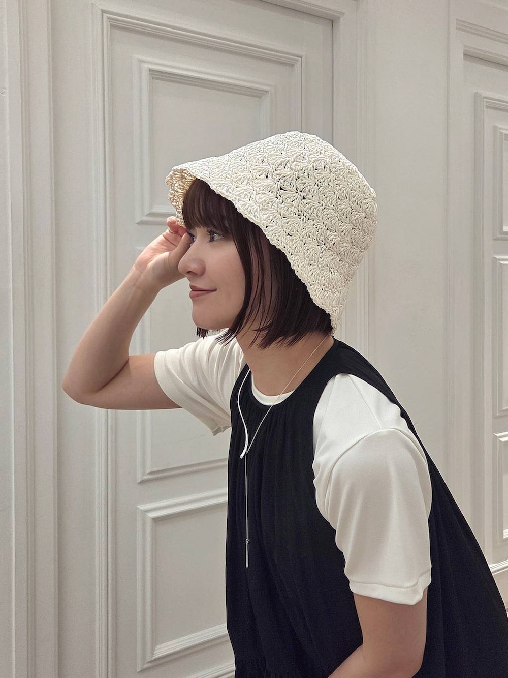 ブラック系のサンダル、ホワイト系のTシャツ/カットソー、ブラック系のワンピースを着用したレディースの春コーディネートの5枚目の写真