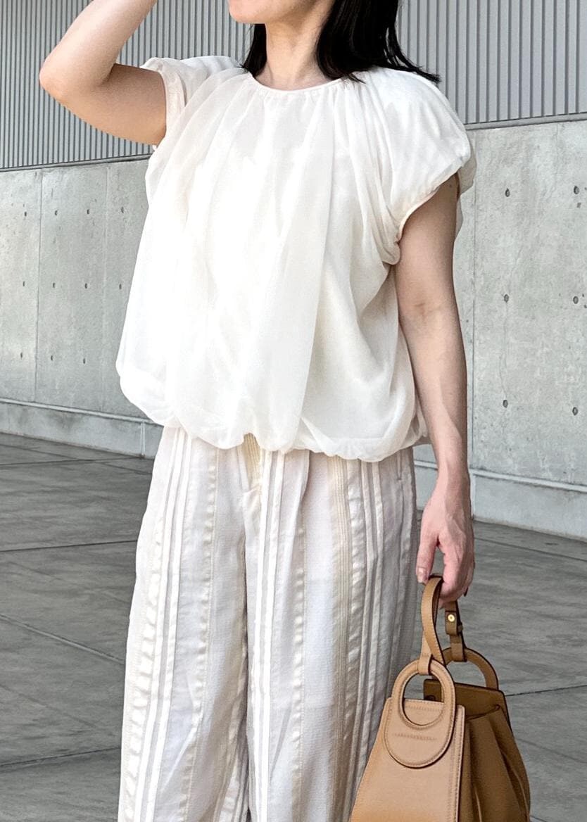 ホワイト系のTシャツ/カットソー、ベージュ系のその他パンツ、イエロー系のハンドバッグを着用したレディースの夏コーディネートの4枚目の写真