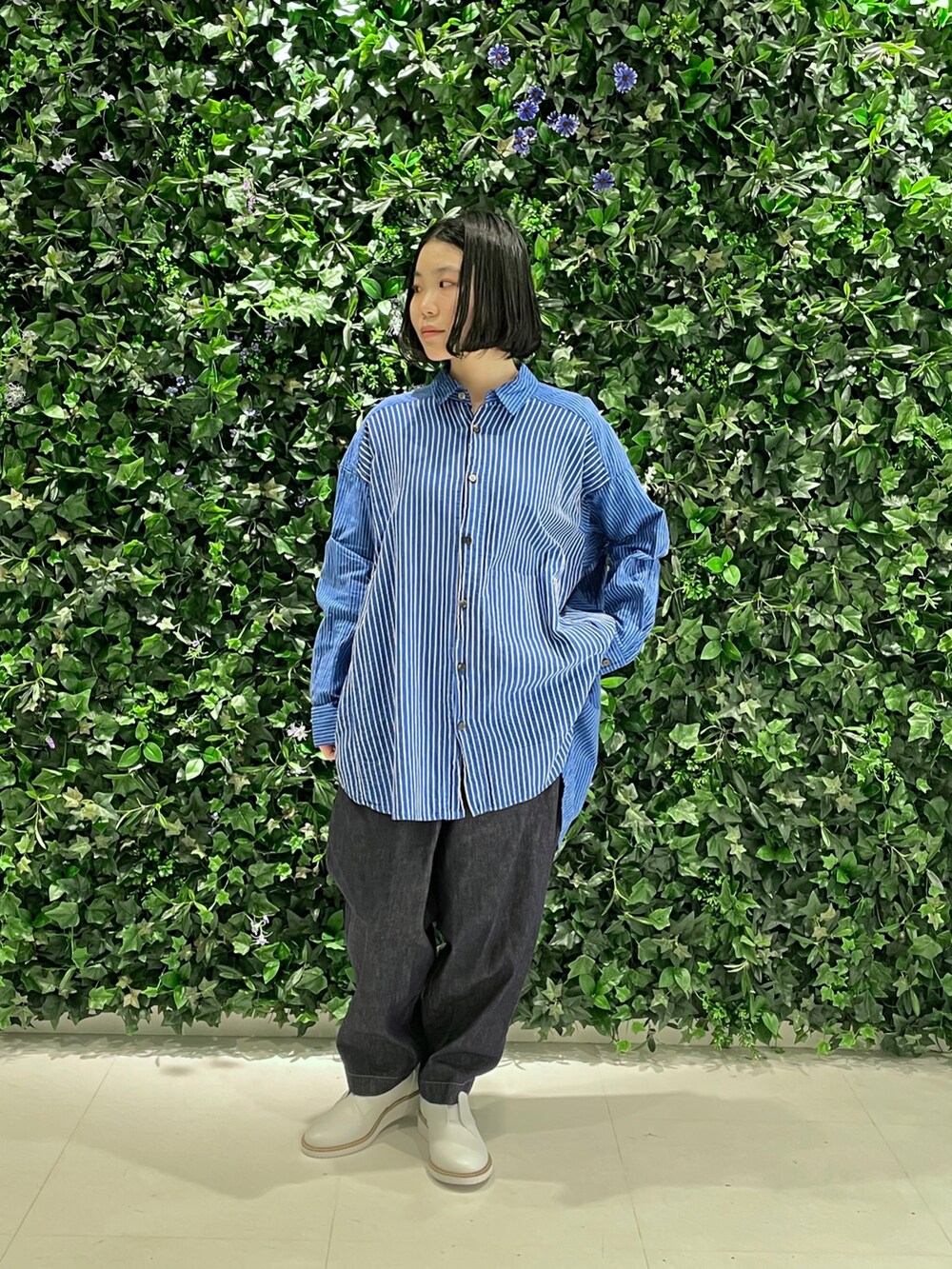 ホワイト系のジャケット/アウター、ブルー系のデニムパンツ、ホワイト系のスリッポンを着用したレディースの冬コーディネートの3枚目の写真