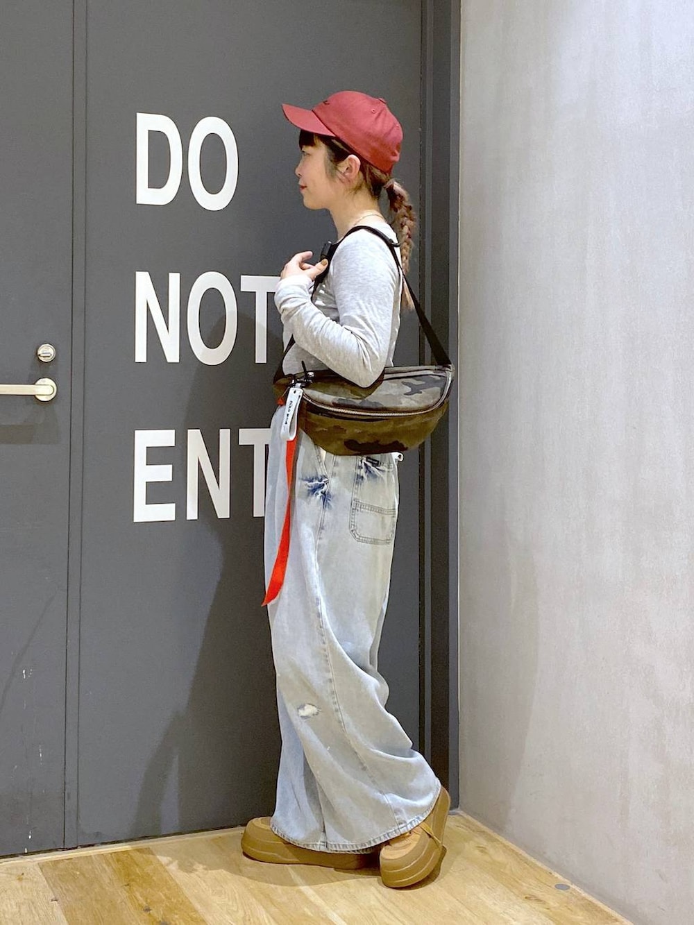 その他のボディバッグ/ウエストポーチ、グレー系のTシャツ/カットソー、ブルー系のデニムパンツを着用したレディースの冬コーディネートの3枚目の写真