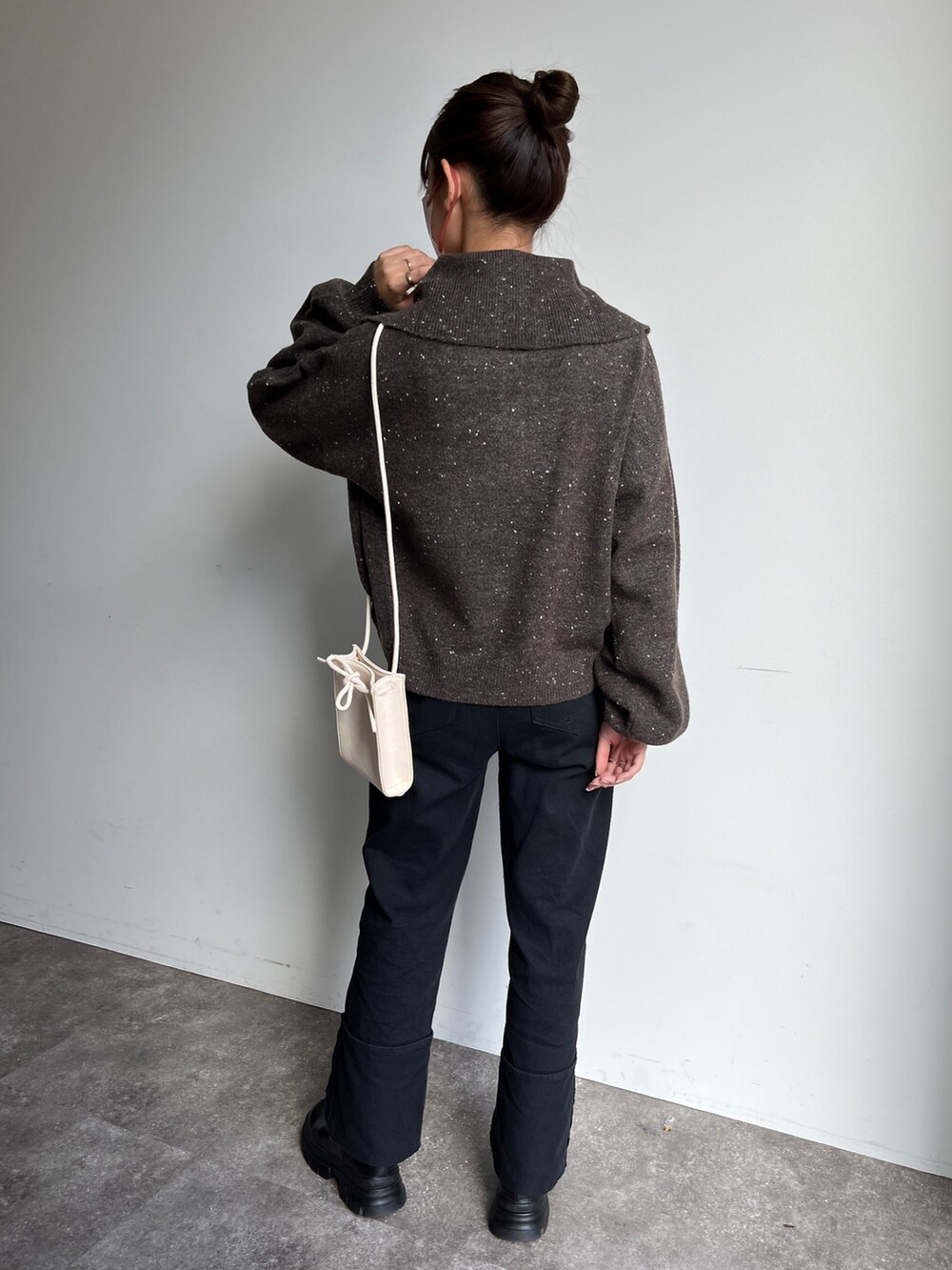 ブラック系のデニムパンツ、ブラック系のニット/セーターを着用したレディースの秋コーディネートの2枚目の写真